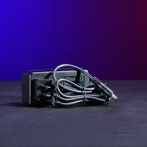 Economical 24V DC replacement wall charger for Astera Titan Tube and Helios Tube fixtures with 5.5mm x 2.1mm barrel connector. SKU: AST-FP1-CHR-ECO